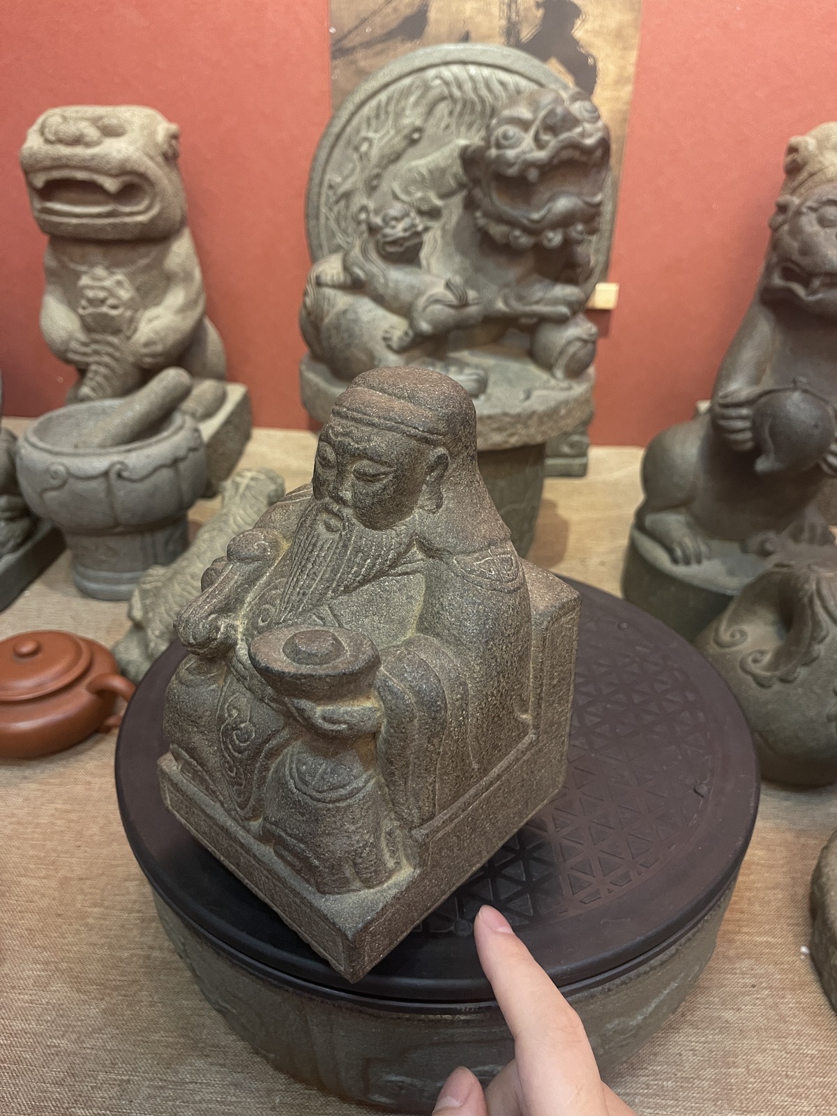 Carved Stone Seated Elder in Relief Panel