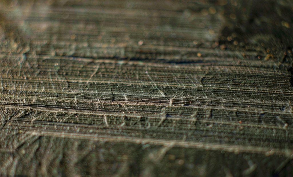 Illustration: close view of chisel marks across a dark stone surface